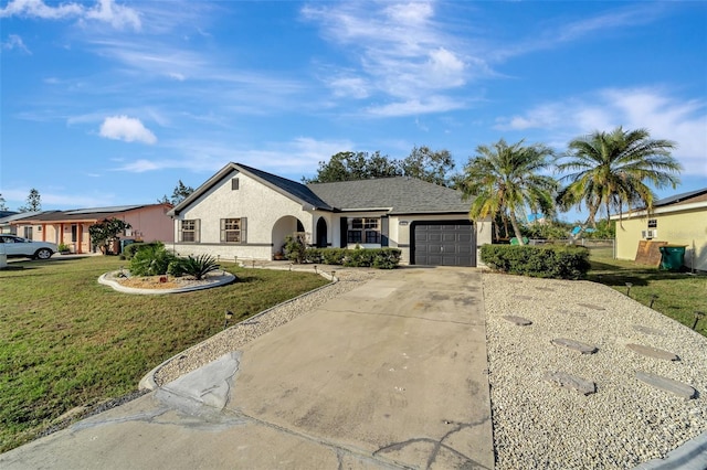 ranch-style house featuring a garage and a front lawn