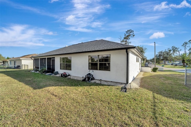 rear view of property with a lawn