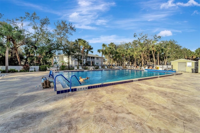 view of swimming pool with a patio area