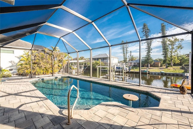 view of pool with a water view, a patio, and glass enclosure