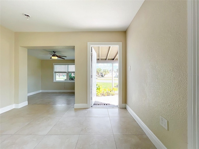 foyer entrance with light tile patterned floors and ceiling fan