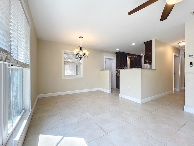 interior space with ceiling fan with notable chandelier