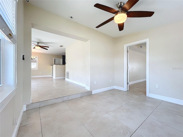 tiled spare room with ceiling fan