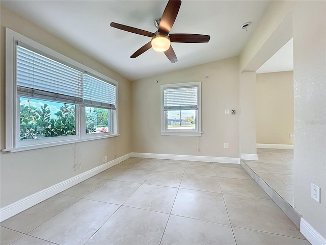 tiled empty room with ceiling fan and lofted ceiling