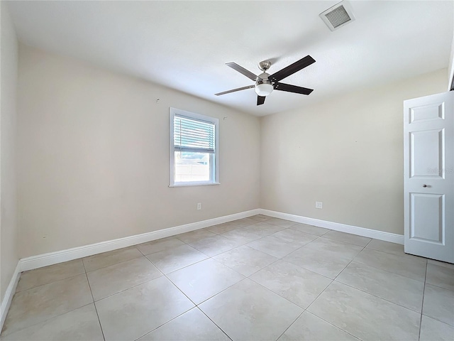 tiled empty room featuring ceiling fan