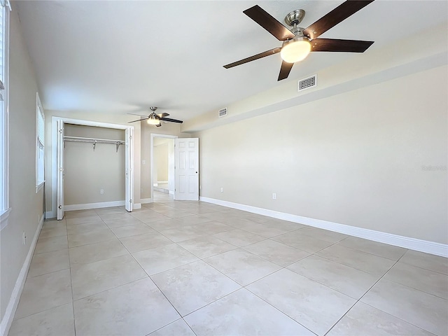 unfurnished bedroom featuring a closet, ceiling fan, and light tile patterned flooring