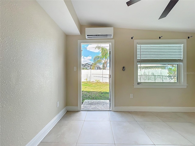 entryway featuring light tile patterned floors, a wall unit AC, and ceiling fan