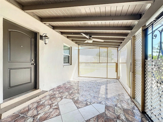 unfurnished sunroom with wood ceiling and beam ceiling