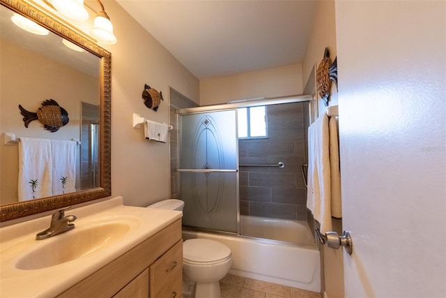 full bathroom with vanity, toilet, tile patterned flooring, and combined bath / shower with glass door