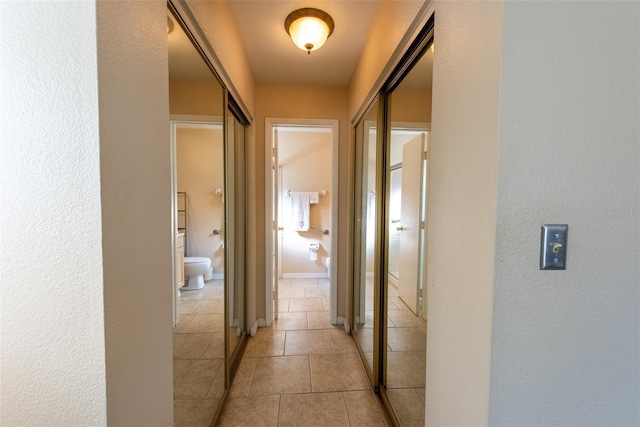 hall featuring light tile patterned flooring