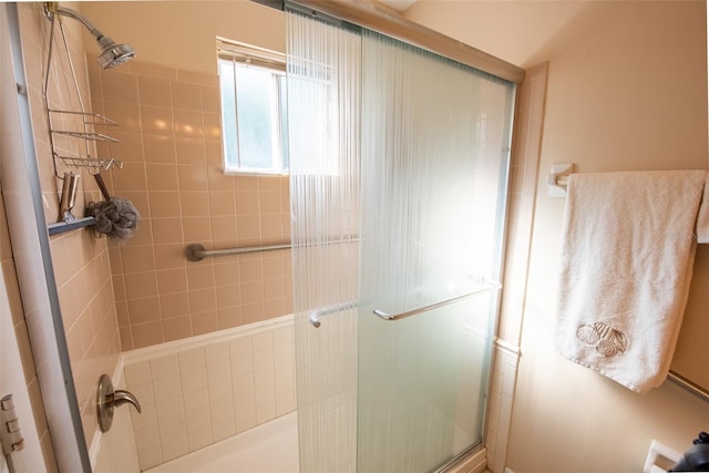 bathroom with a shower with door