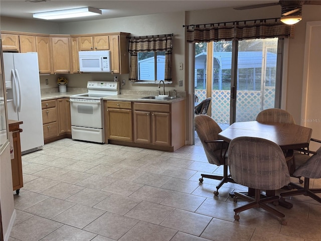 kitchen featuring light countertops, visible vents, a ceiling fan, a sink, and white appliances