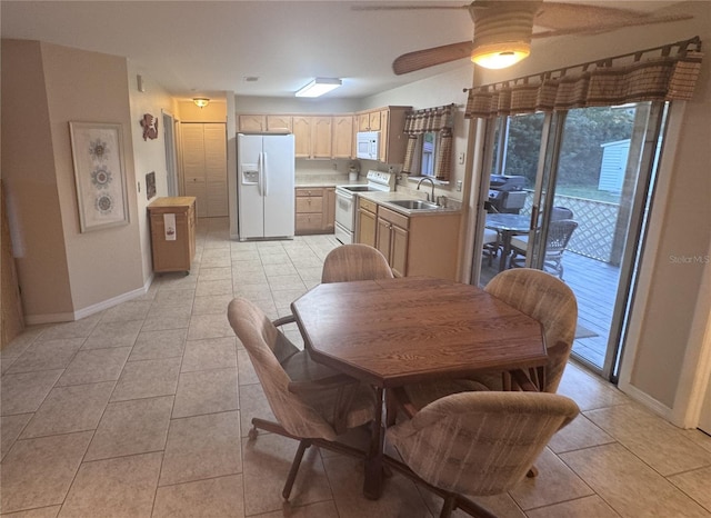 dining room with baseboards, a ceiling fan, and light tile patterned flooring