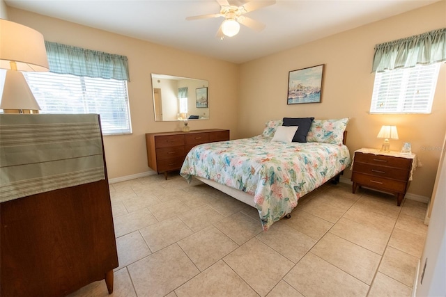 bedroom with ceiling fan, baseboards, and light tile patterned flooring