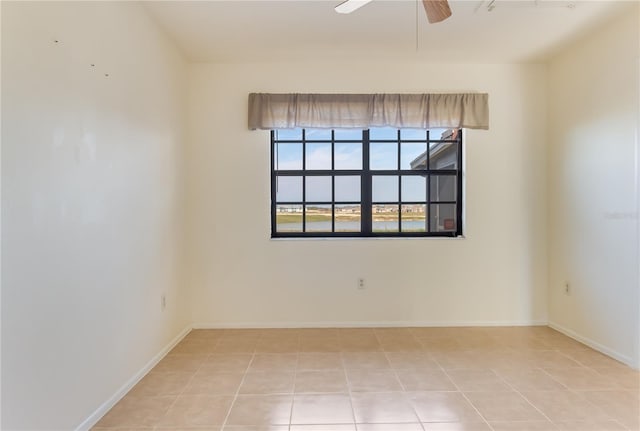 empty room with light tile patterned flooring and ceiling fan