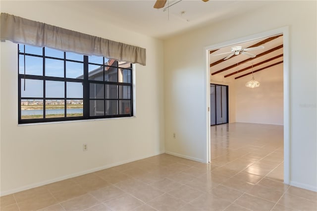 empty room featuring light tile patterned flooring, vaulted ceiling with beams, and ceiling fan