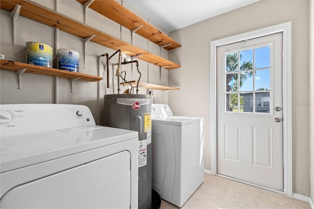 washroom with water heater and washing machine and dryer