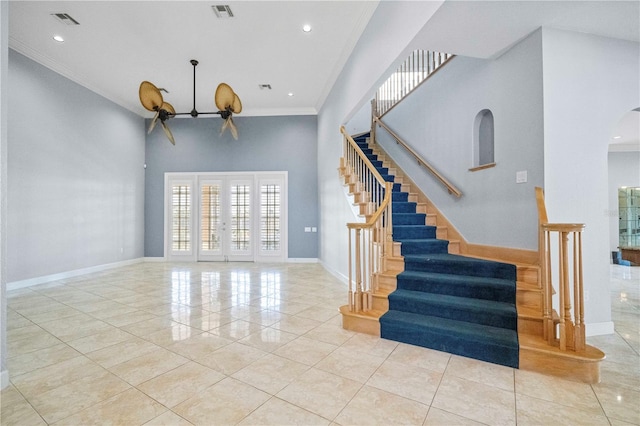 interior space with ornamental molding, french doors, and a high ceiling