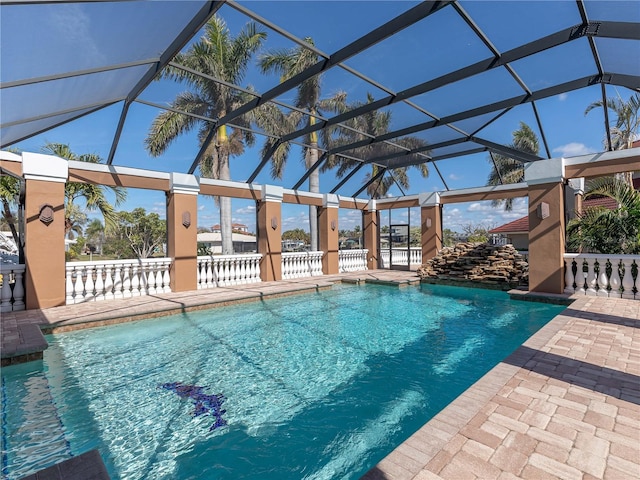 view of swimming pool with a patio and glass enclosure