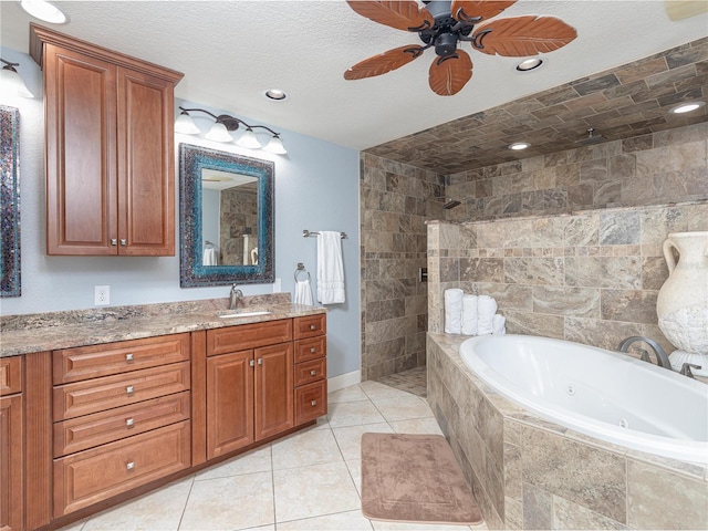 bathroom with ceiling fan, tile patterned flooring, vanity, plus walk in shower, and a textured ceiling