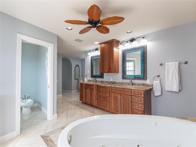 bathroom with a bathing tub, tile patterned flooring, vanity, ceiling fan, and a bidet