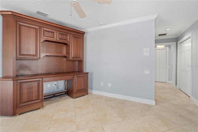 unfurnished office with crown molding, ceiling fan, built in desk, and light tile patterned floors