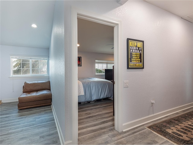 corridor with hardwood / wood-style floors