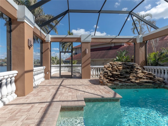 view of swimming pool featuring a lanai