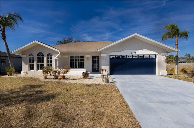 ranch-style house with a garage and a front lawn