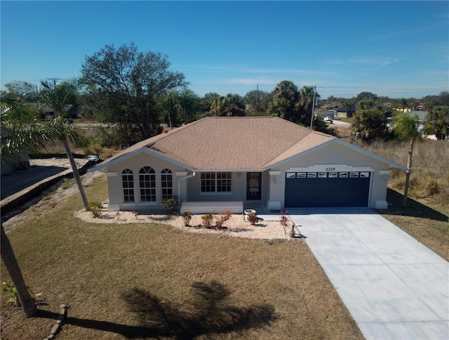 single story home with a garage and a front lawn