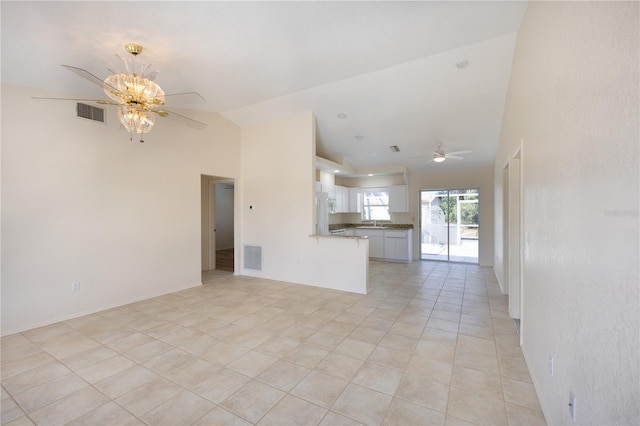 unfurnished living room with lofted ceiling, light tile patterned floors, sink, and ceiling fan