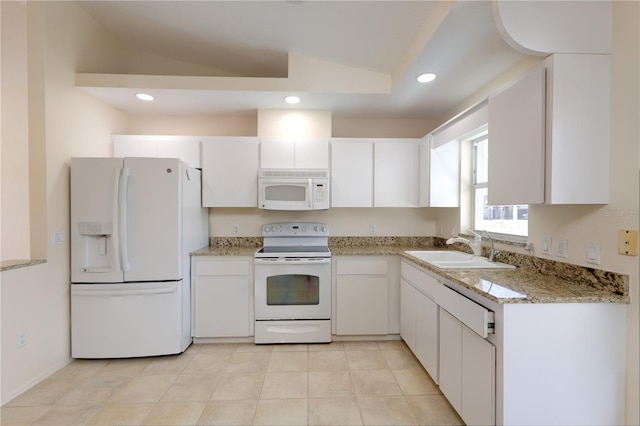 kitchen with vaulted ceiling, sink, white cabinets, light stone counters, and white appliances