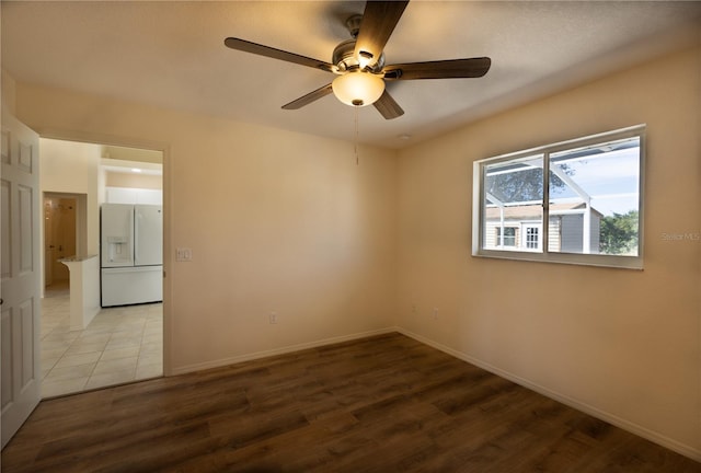 empty room featuring ceiling fan and light wood-type flooring