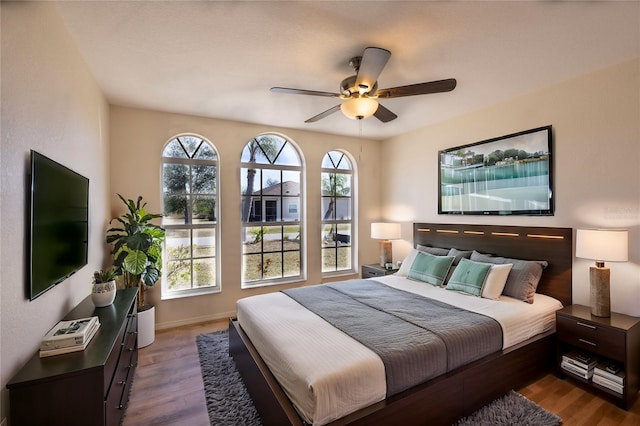 bedroom with ceiling fan and wood-type flooring