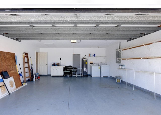 garage featuring a garage door opener, washing machine and dryer, and electric water heater