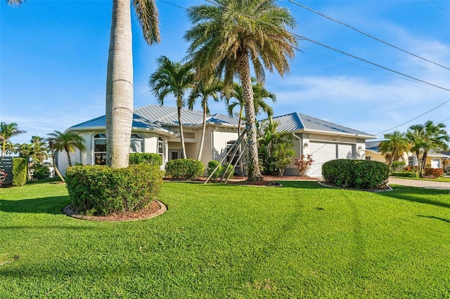 single story home featuring a garage and a front lawn