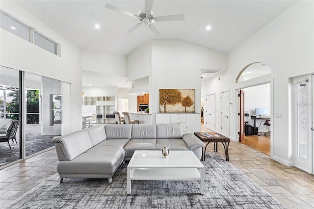 living room with ceiling fan and high vaulted ceiling