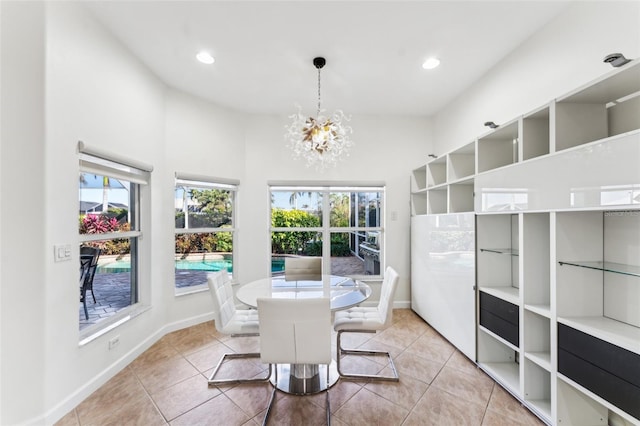 tiled dining space with a chandelier