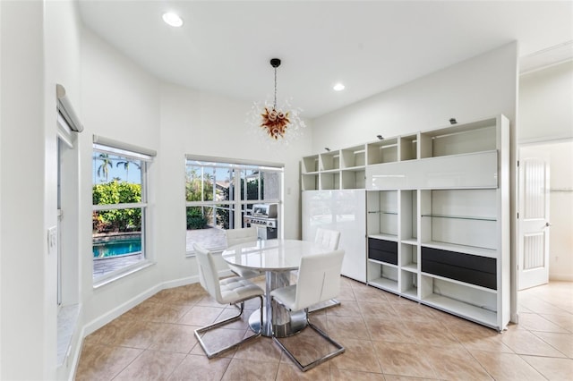 tiled dining room with an inviting chandelier and a towering ceiling