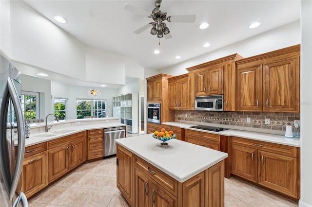 kitchen featuring light tile patterned flooring, sink, appliances with stainless steel finishes, a kitchen island, and backsplash