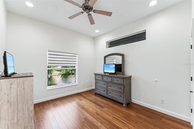 unfurnished bedroom with ceiling fan and wood-type flooring