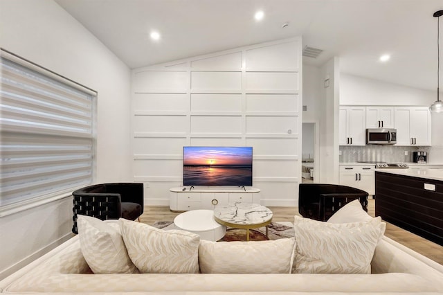 living room with lofted ceiling and light wood-type flooring