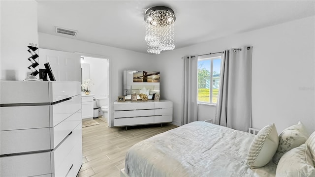 bedroom with an inviting chandelier and ensuite bath