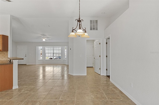 unfurnished dining area featuring light tile patterned flooring and ceiling fan