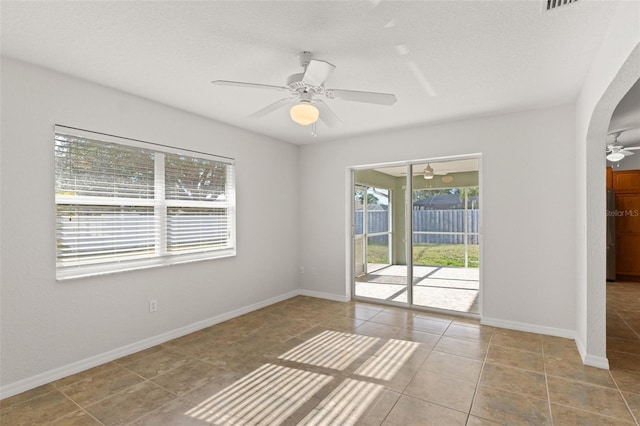 unfurnished room with light tile patterned flooring, ceiling fan, and a textured ceiling