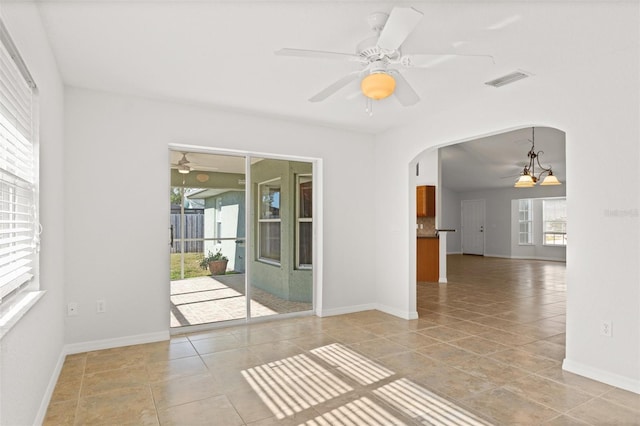 tiled empty room featuring ceiling fan