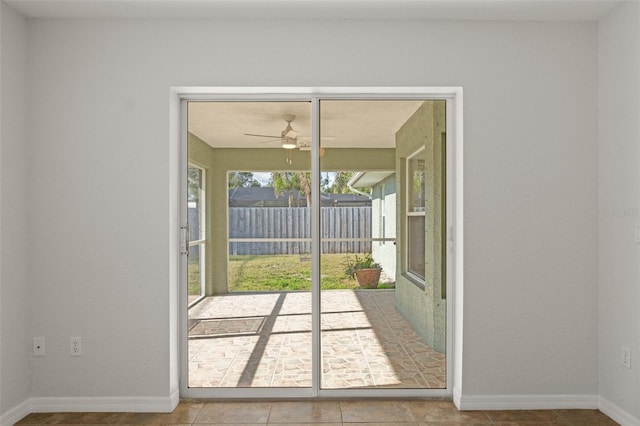 doorway with ceiling fan