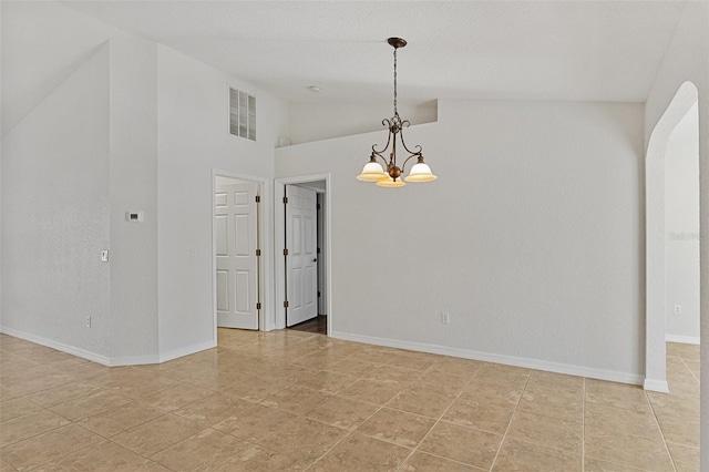 empty room featuring an inviting chandelier, high vaulted ceiling, and light tile patterned flooring