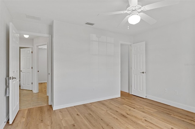 spare room with ceiling fan and light hardwood / wood-style floors