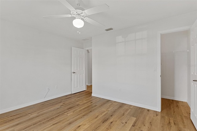 unfurnished room with ceiling fan and light wood-type flooring